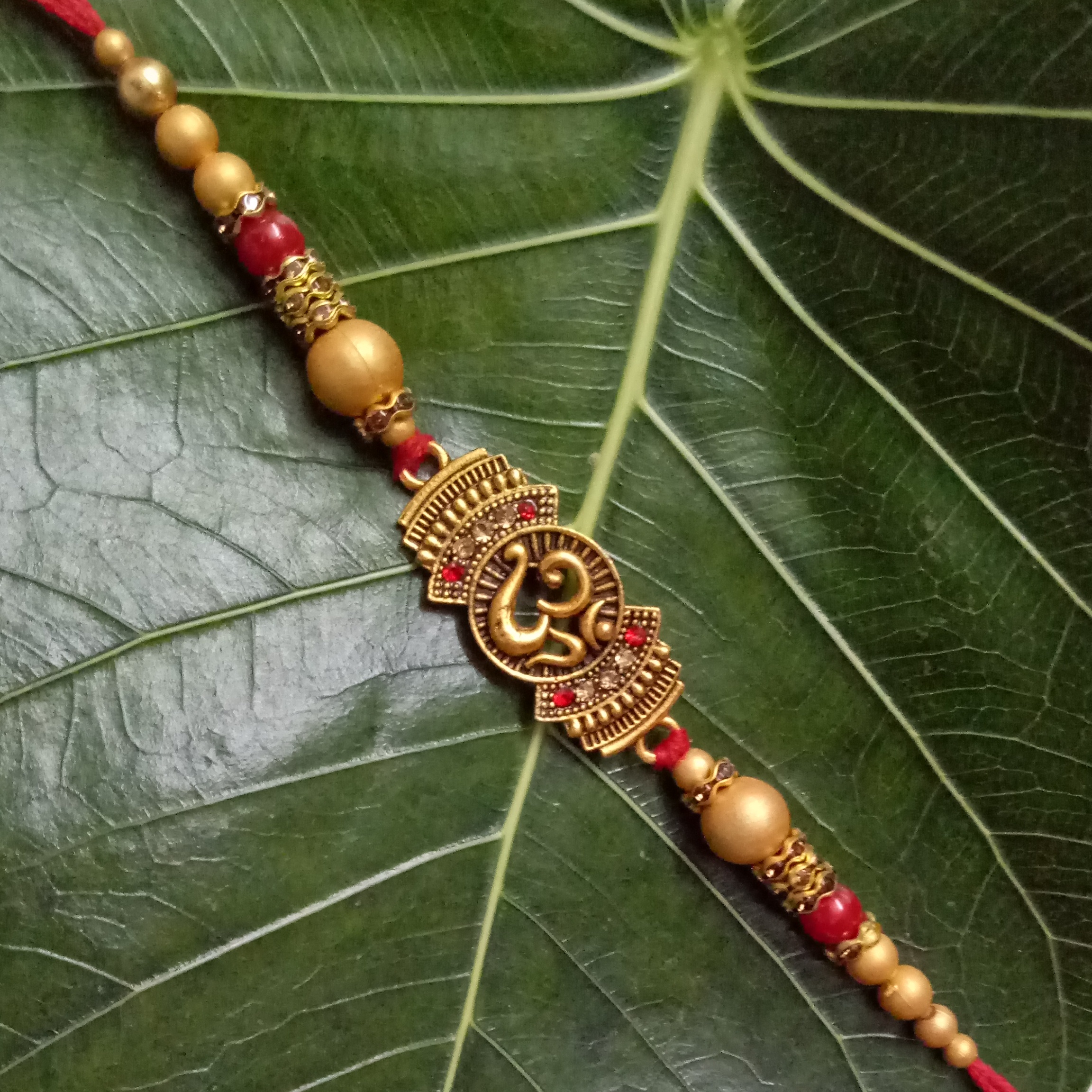 Om Designer Rakhi with Beads - Image 2